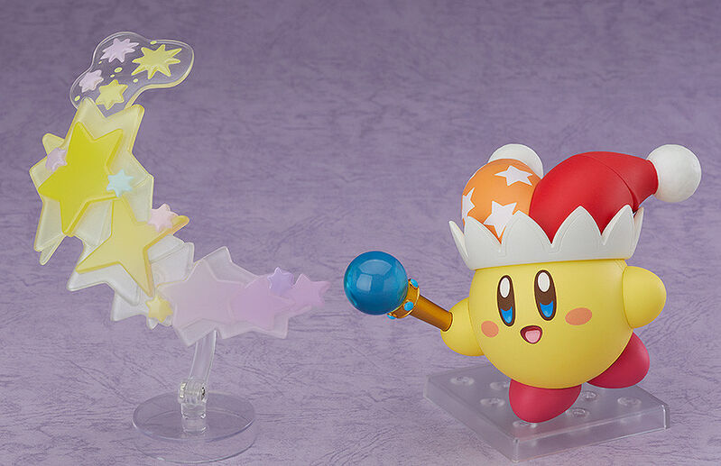 Good Smile Nendoroid Kirby Beam Kirby with dynamic beam effect parts golden stars explosion star rod blue orb red hat orange stars display stand purple background Nintendo chibi action pose collectible figure