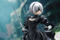 NieR Automata 2B 1/7 figure close-up sword draw blindfold pose black dress ruins backdrop